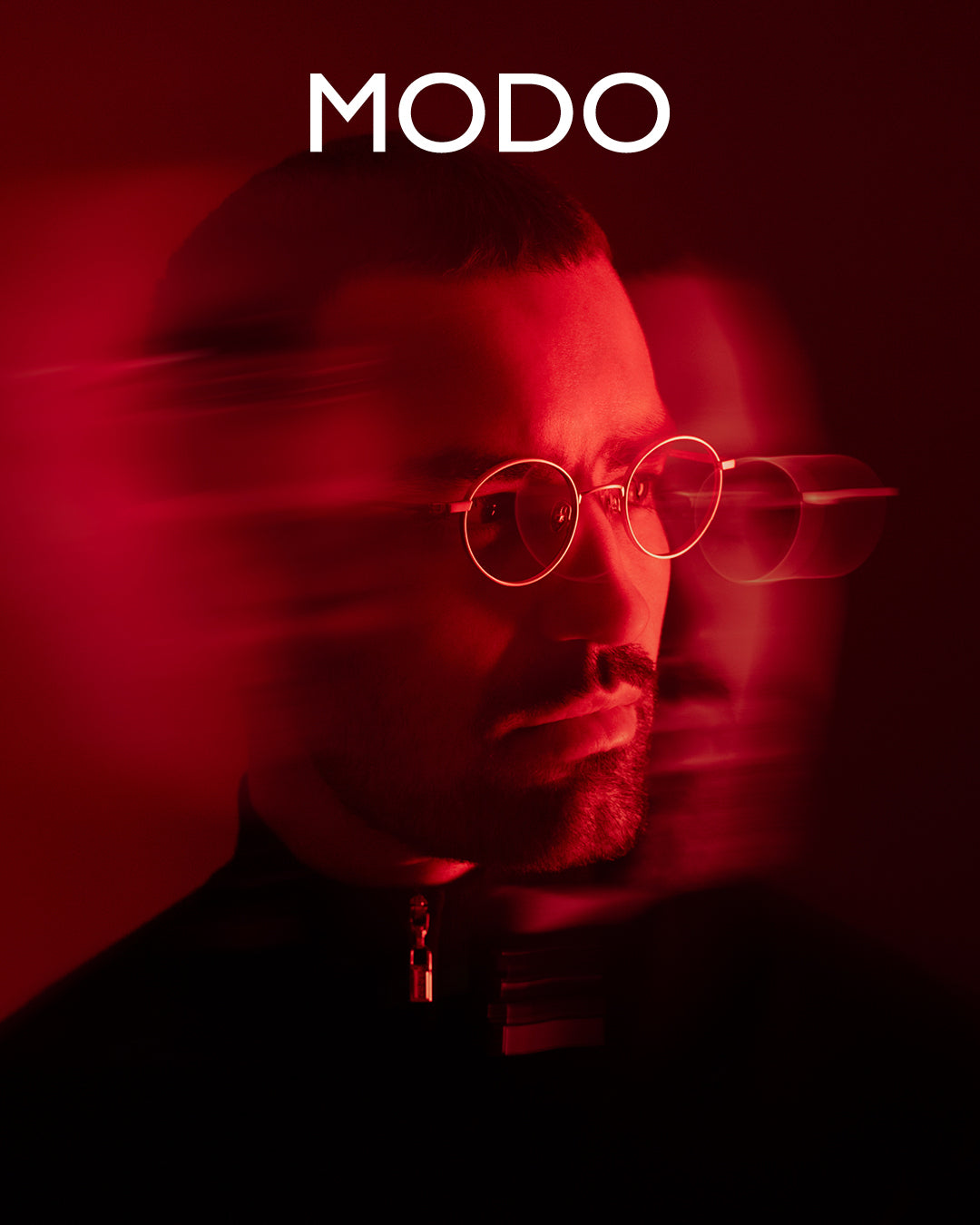 MODO Eyewear campaign featuring male model in gold metal eyeglasses with blurred effect, red lighting, and dark red background – luxury men’s eyewear fashion photography.