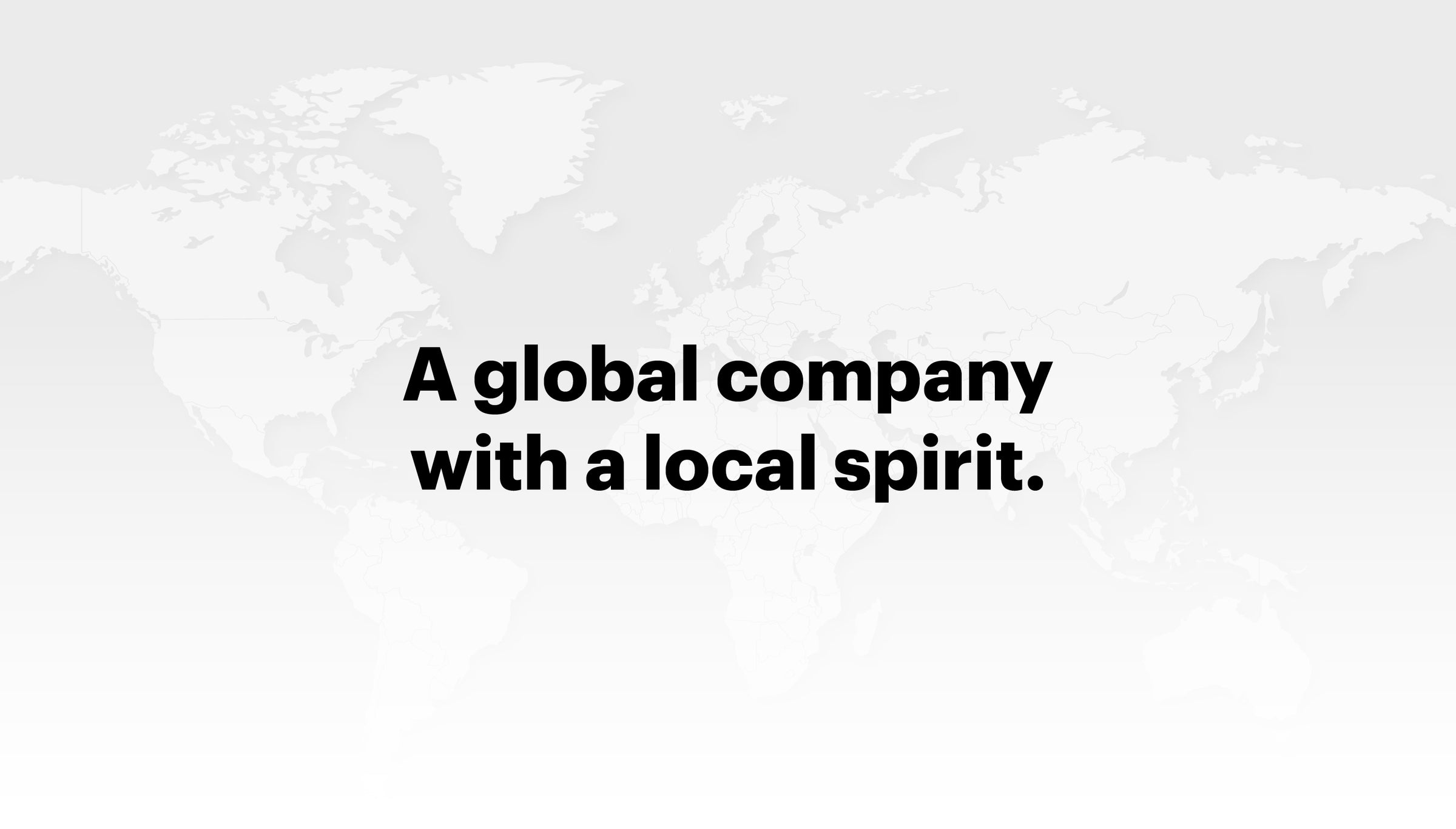 Graphic image featuring a world map background with text overlay ‘A global company with a local spirit.’
